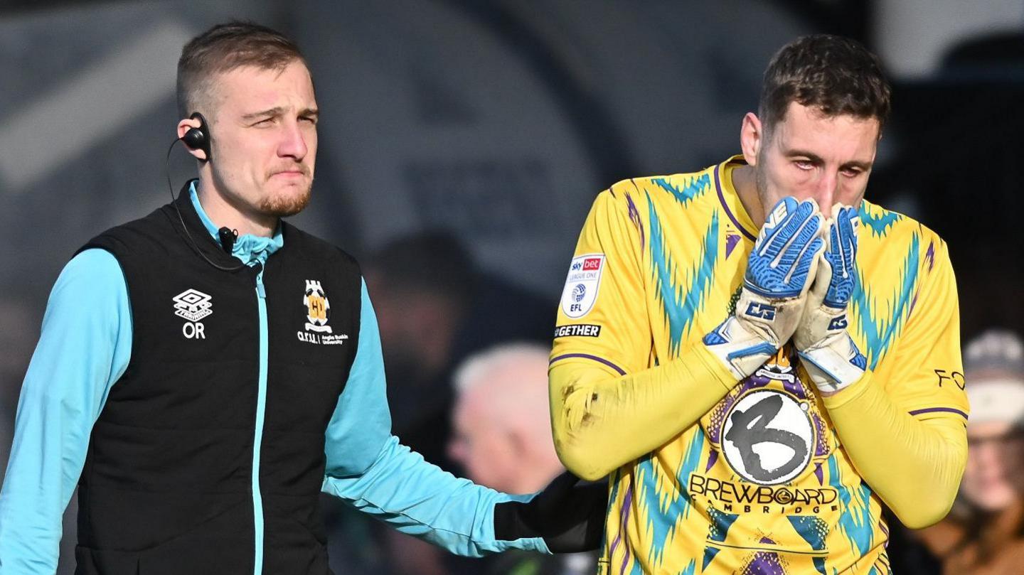 Cambridge United physio with goalkeeper Marko Marosi