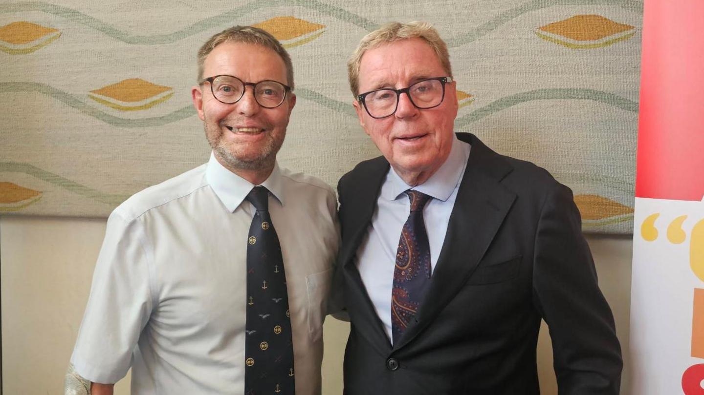 Two smartly dressed men with glasses.