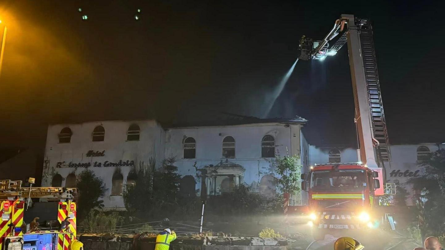 Fire crews hosing down after the fire at La Gondola