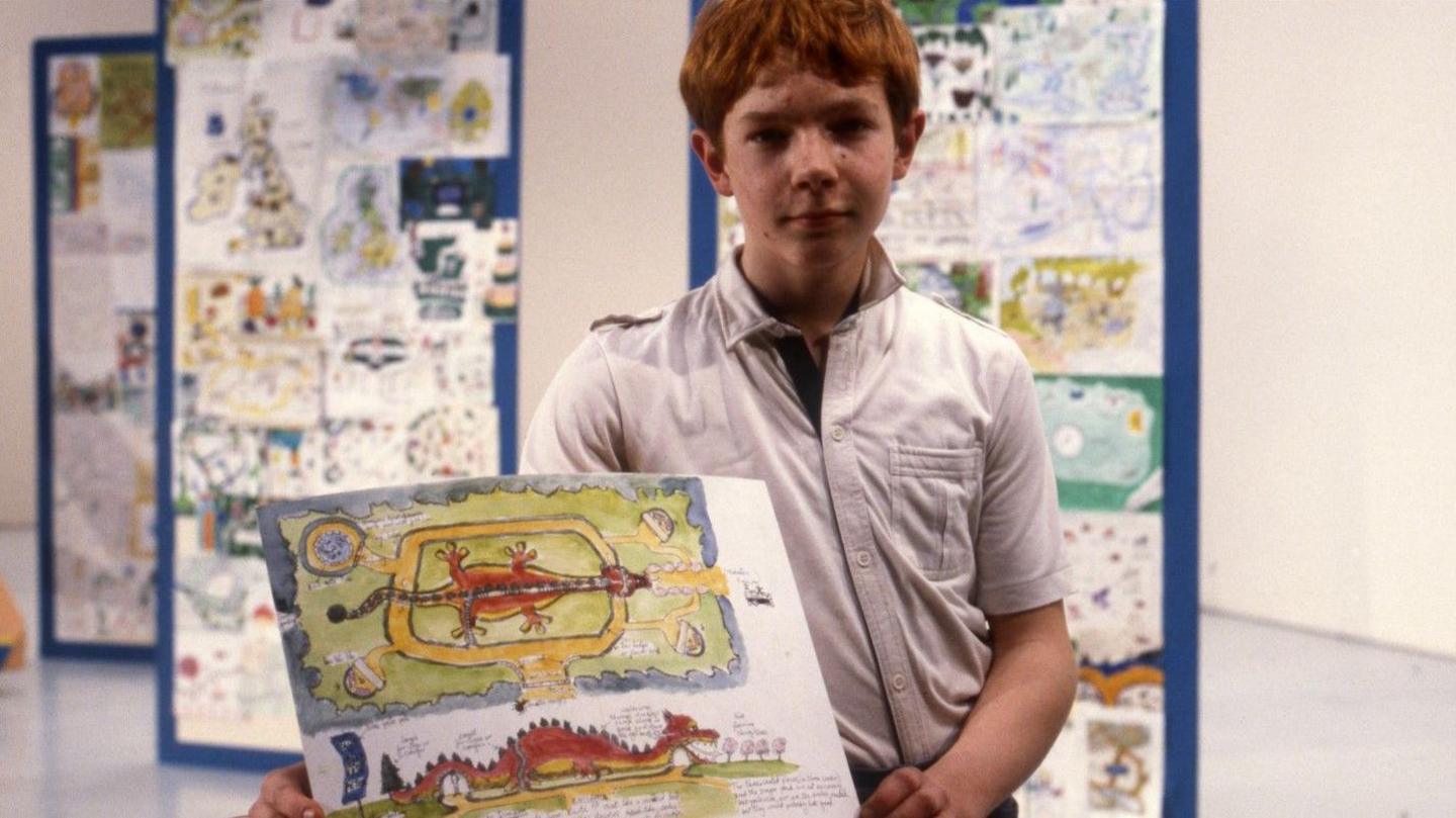 Theo Gay Anderson, aged 13 in 1984, displays his winning entry of a dragon-themed garden complete with a dragon slide.