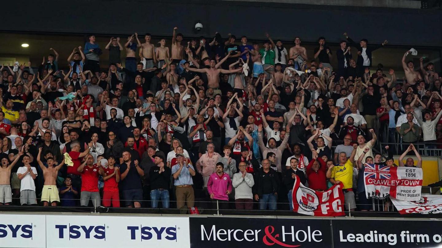 Crawley fans celebrating in the stands at Stadium MK