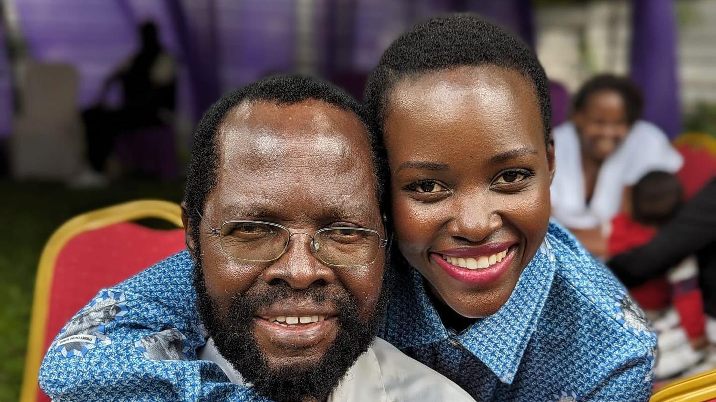 Anyang' Nyong'o and his daughter Lupita Nyong'o embrace and pose for a photo 