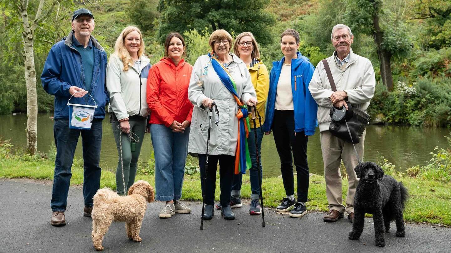 Sheila with six members of Ilkley Good Neighbours charity, and two dogs, walking at the tarn