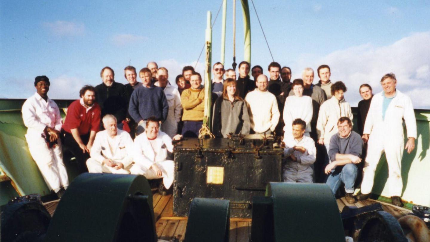 A group photo of those onboard the Discovery