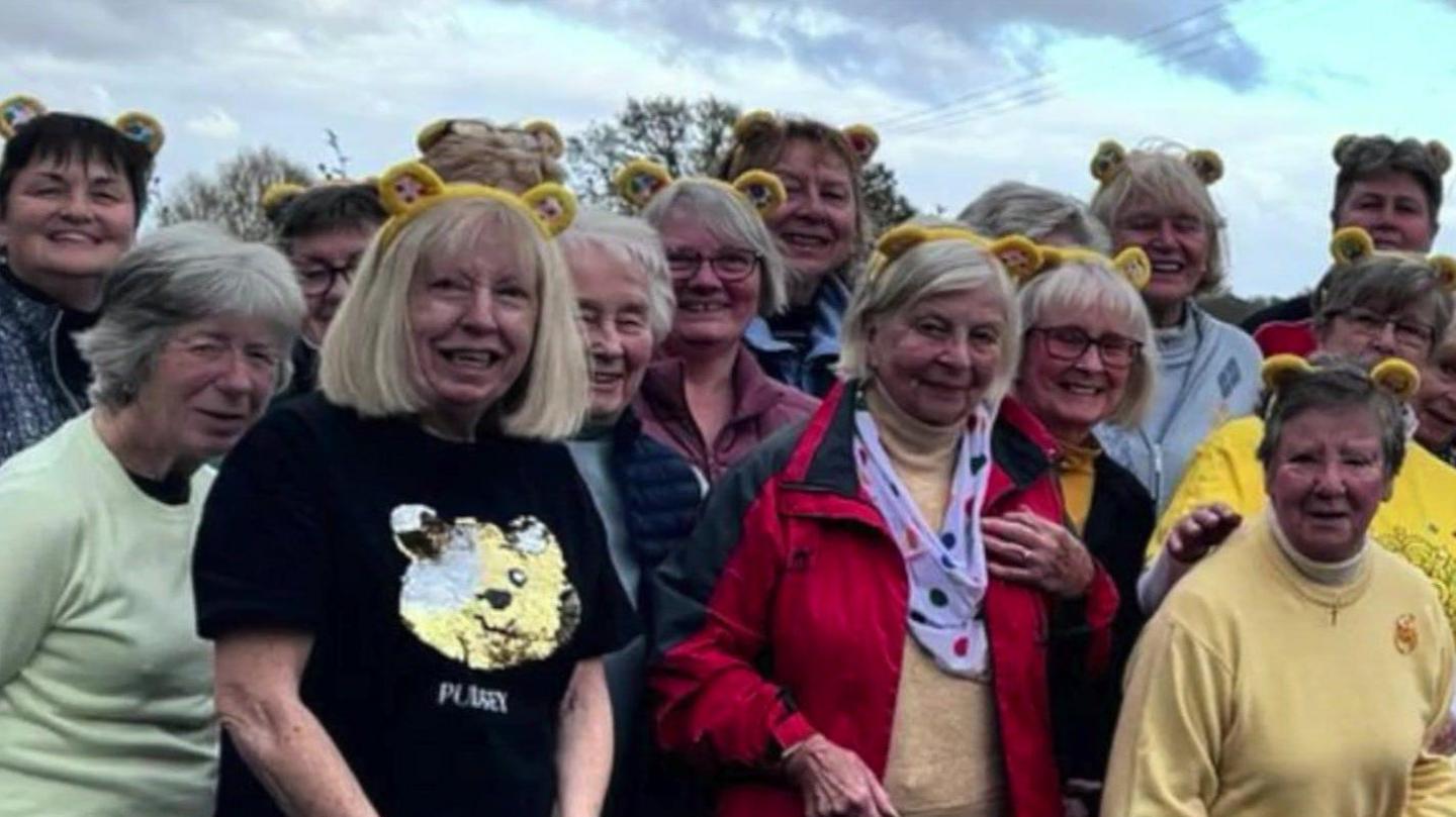 Women and men from Deanwood Park Golf  some wearing yellow Pudsey style ears