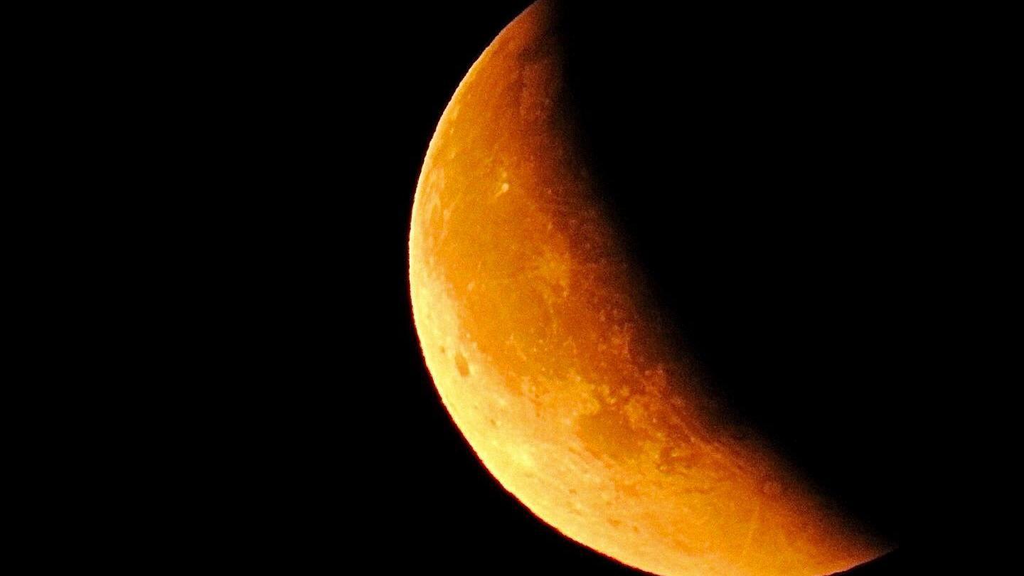 An orange tinted half moon.