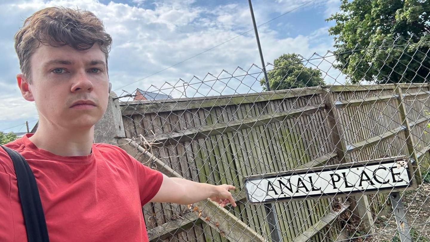 Councillor James Vivian with the 'Anal Place' road sign