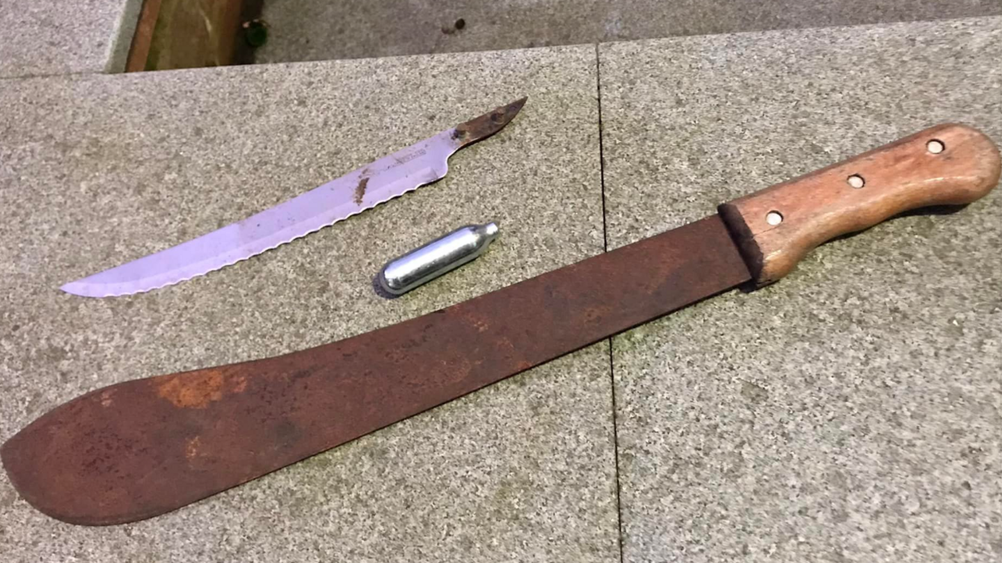 A knife blade, a metal canister and a rusty Machete