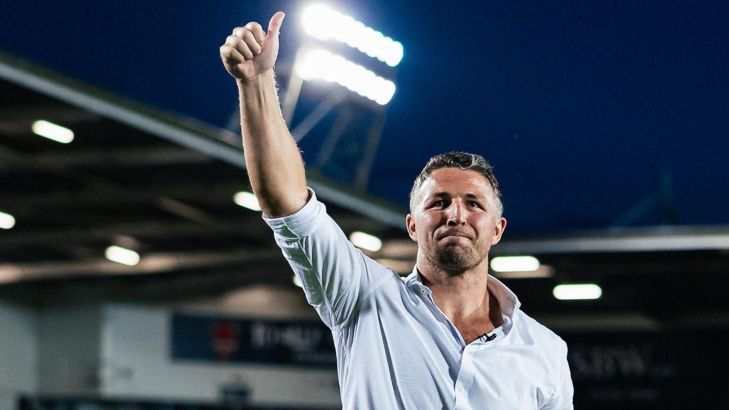 Warrington Wolves boss Sam Burgess gives a thumbs-up gesture to fans