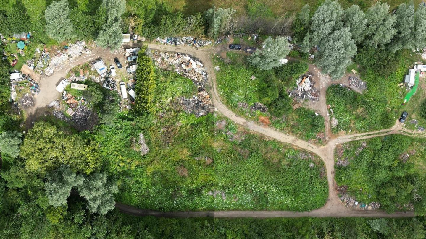 A view of the green Woburn Sands site taken from above by a drone. There are dirt tracks leading to large piles of grey ash and debris.