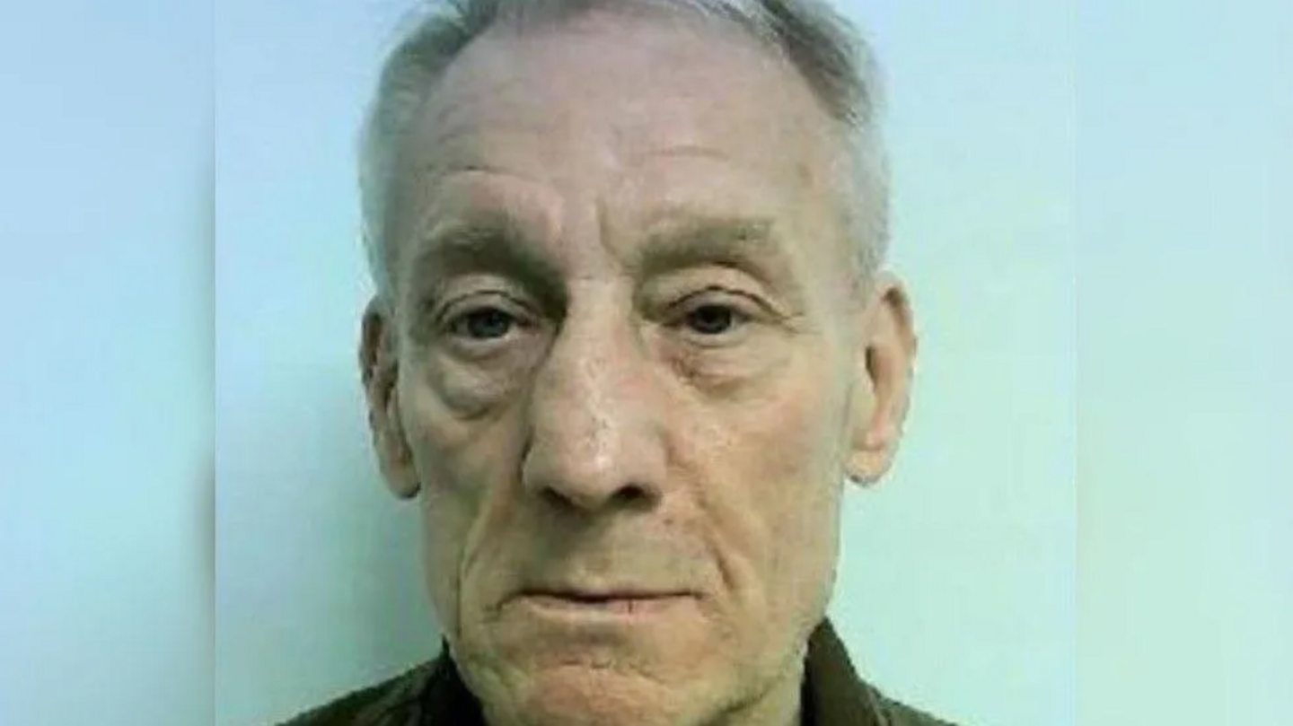 A police-issued image of Stephen Grimes. He is staring into the camera and has dark coloured eyes and grey/white hair. 