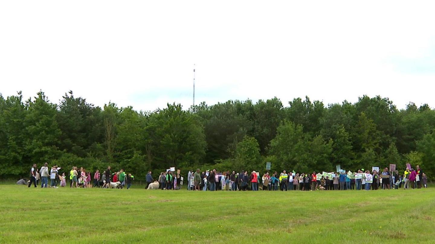 Group of people in a field holding a protest