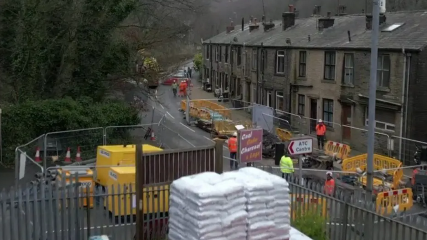 Extensive road works on a road on which there are terraced homes.