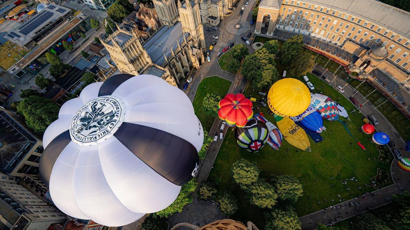 A cluster of colourful hot air balloons are seen from above as they are inflated ready for a media launch to publicise the Bristol International Balloon Fiesta