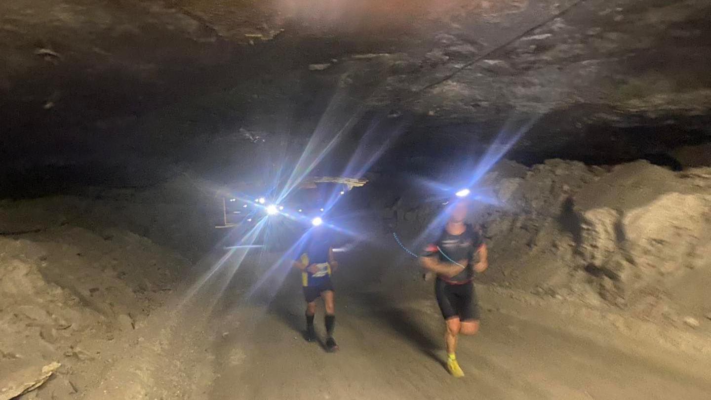 Runners wearing headtorches running through the disused salt mines during the Kristallmarathon