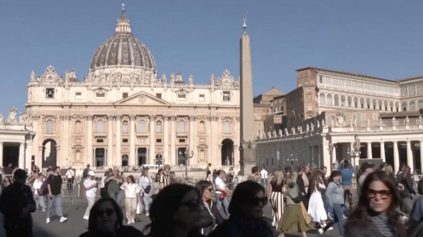 crowds outside the Sistine Chapel in Vatican City on a sunny day