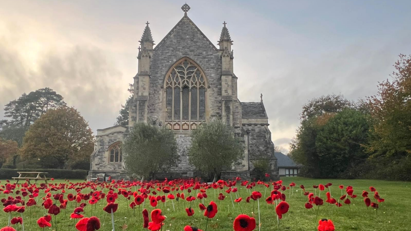 Church with knitted red poppies in the church grounds.
