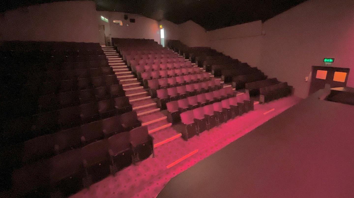 Rows of red cinema seats inside Hollywood Plaza