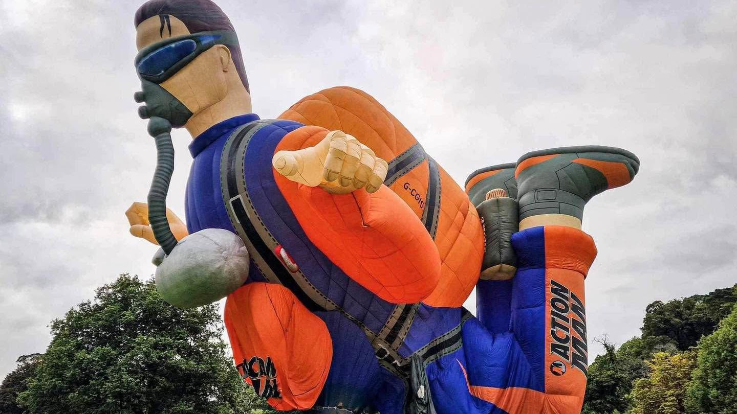 An Action Man hot air balloon in a skydiving pose, equipped with a parachute and a pack.