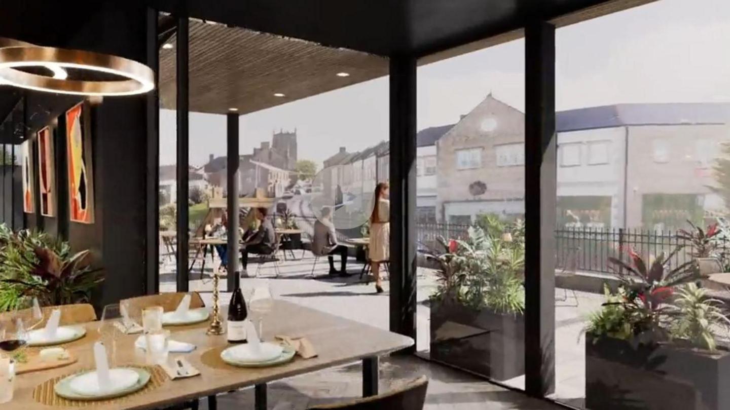 A view from inside a planned restaurant with terrace, looking out onto a road with housing and shops