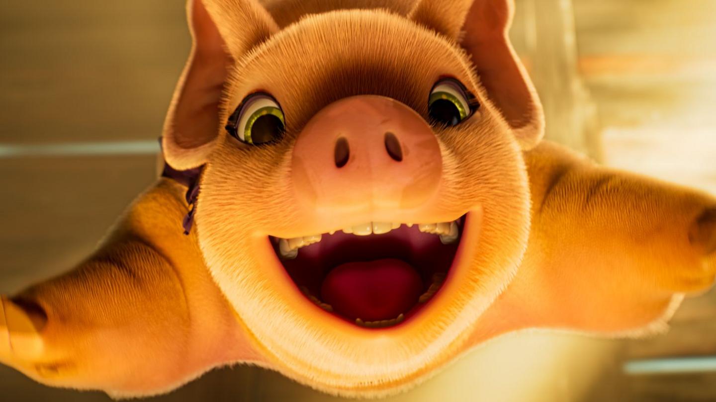 A still image from Animal Farm showing a pig smiling at the camera with outstretched legs