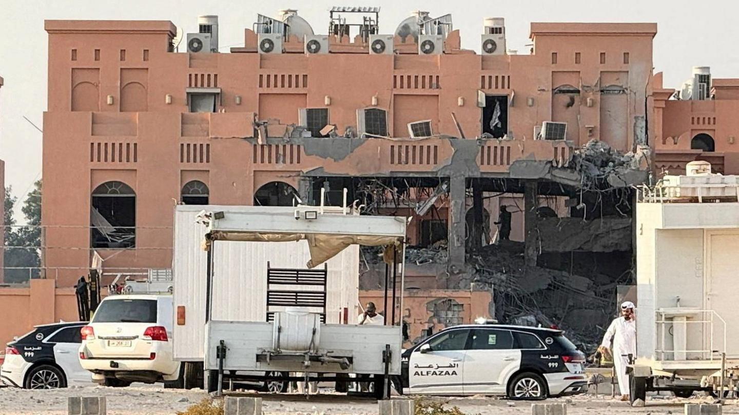 A damaged building in Doha, following an Israeli attack on Hamas leaders. Police vehicles are parked outside, with sirens blaring.