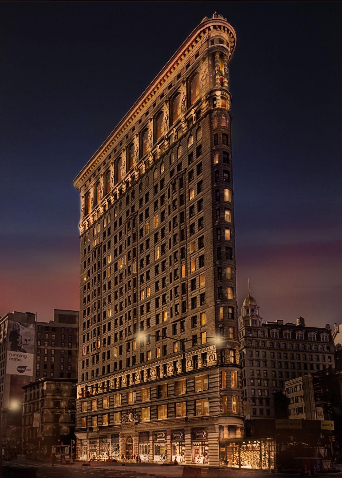 rendering of the Flatiron Building seen from the outside at night, with lights illuminating its sides