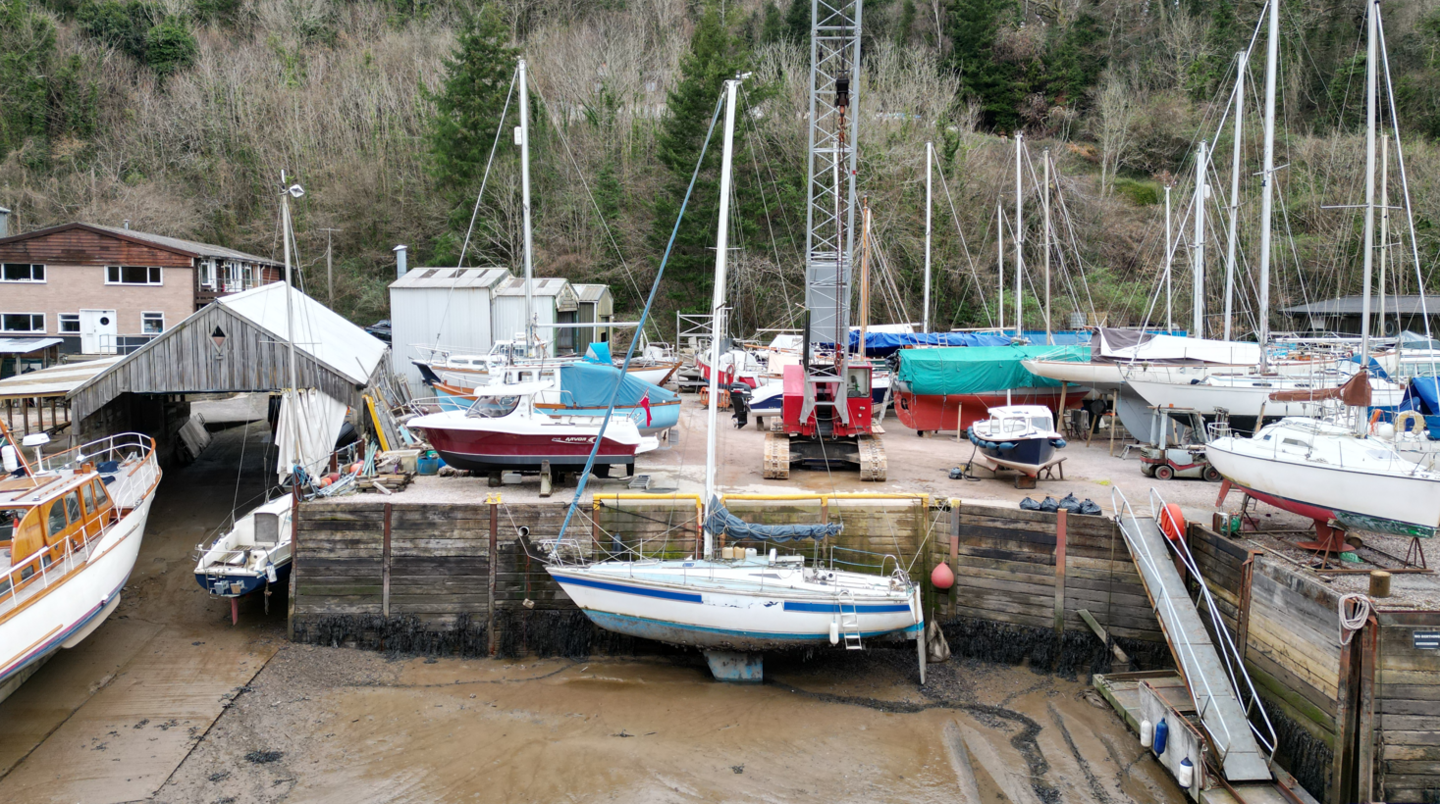 Abandoned boat being lifted out of the water at Creekside Boatyard in Dartmouth