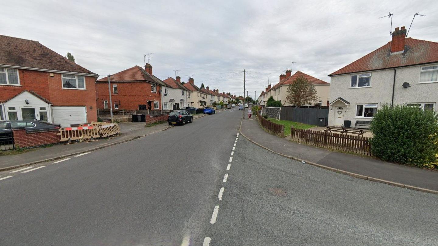 A generic photo showing Regent Street going from the bottom left to the centre of the photo. It is pictured at the junction with Pine Tree Road, which is on the right. Houses and cars are on both sides of Regent Street.