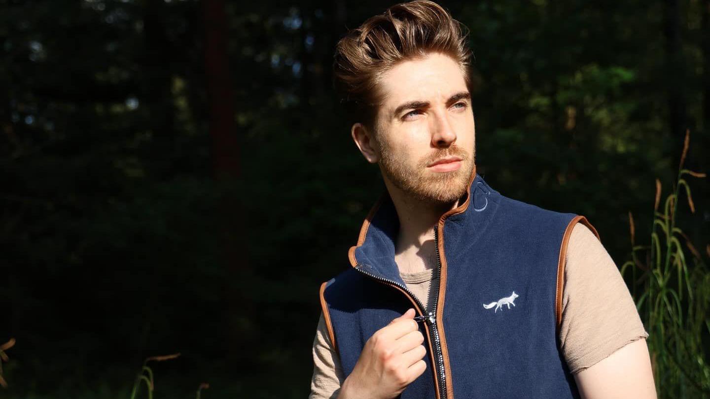 A male model posing in a navy Cotswold Fox gilet