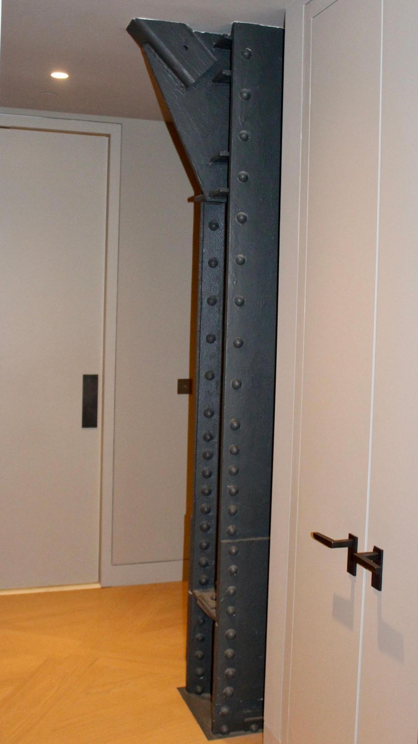 A steel support beam exposed in a hallway