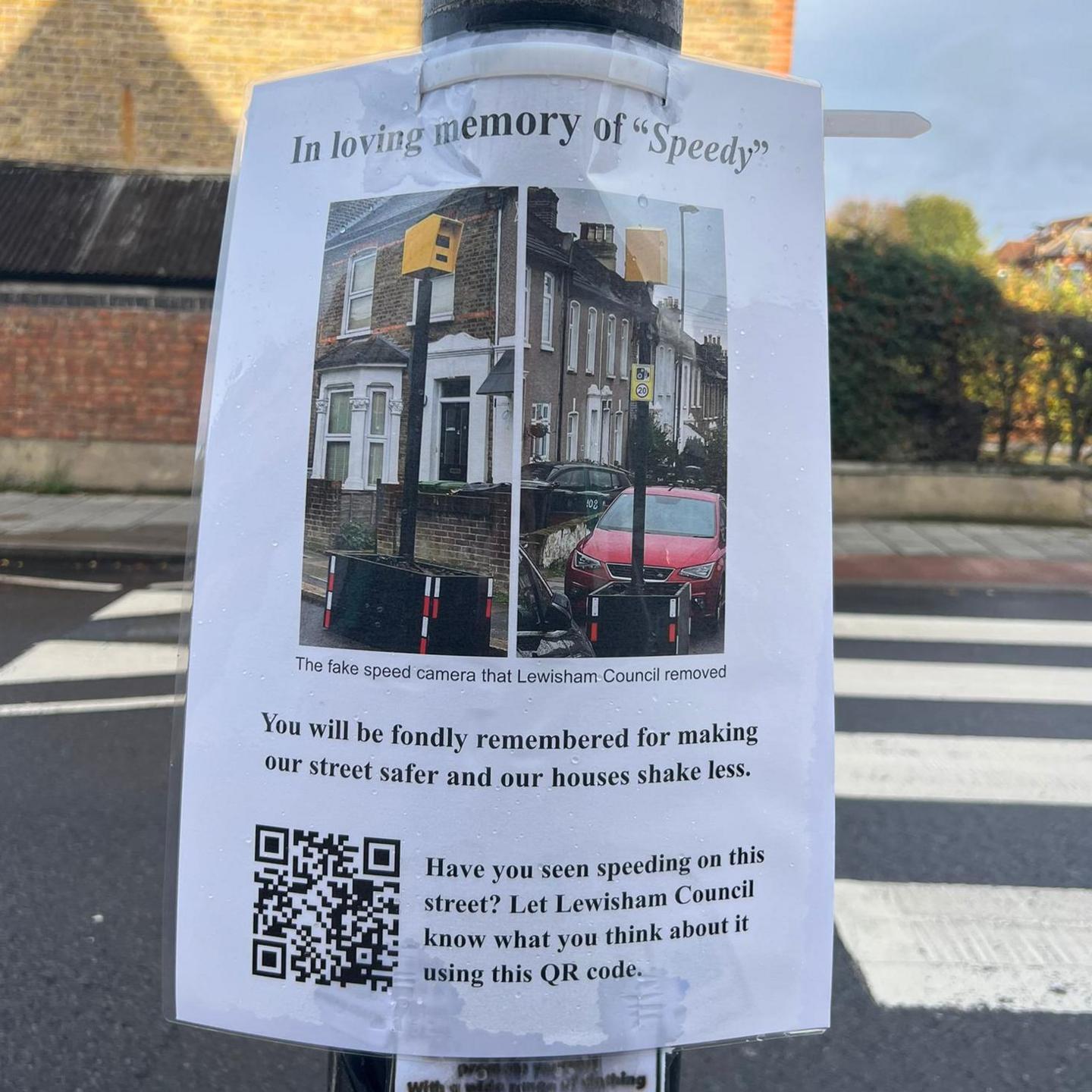 Sign on lampost reads 'in loving memory of speedy' with a QR code below some text saying it will be 'fondly remembered'