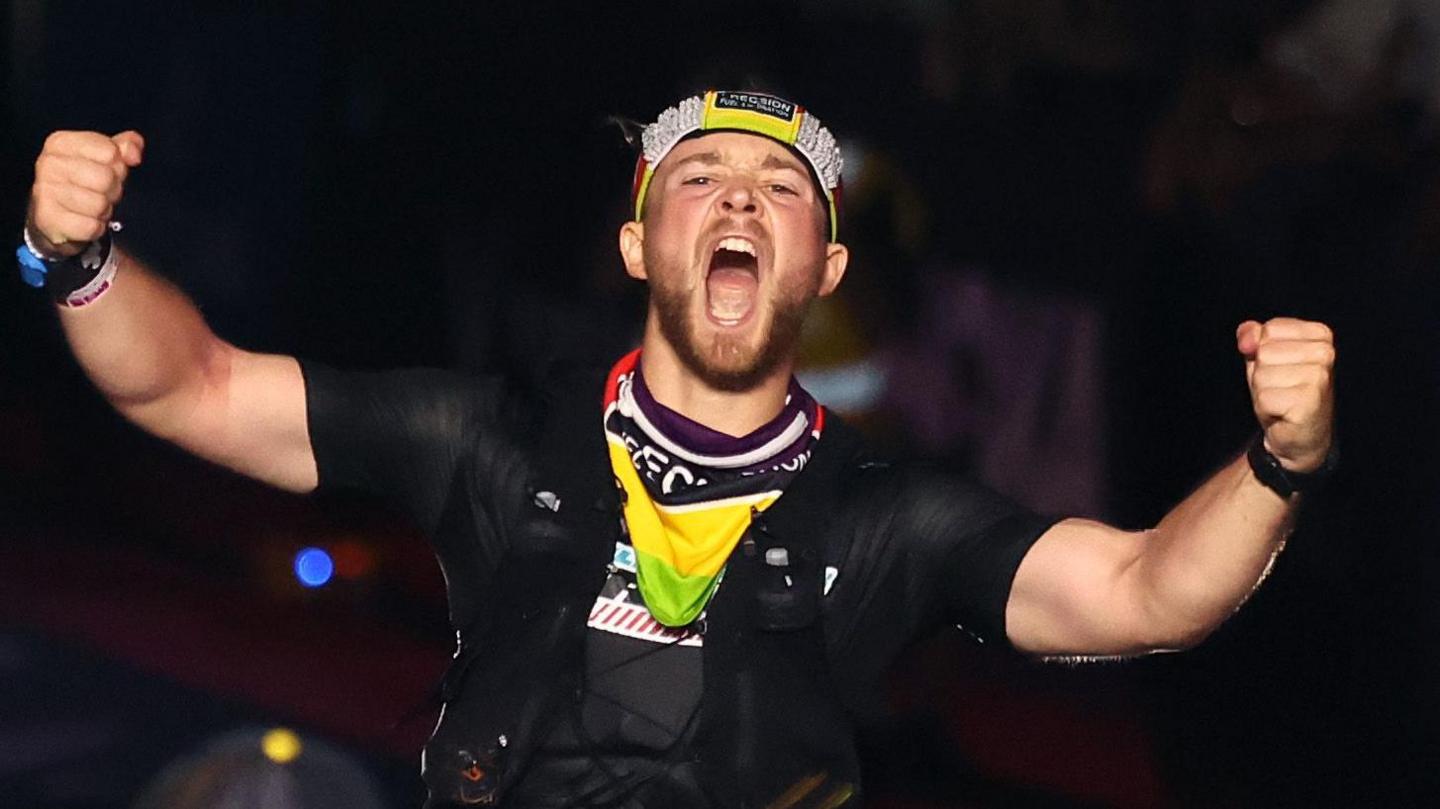 Billy Monger celebrates crossing the line at the Ironman World Championship 