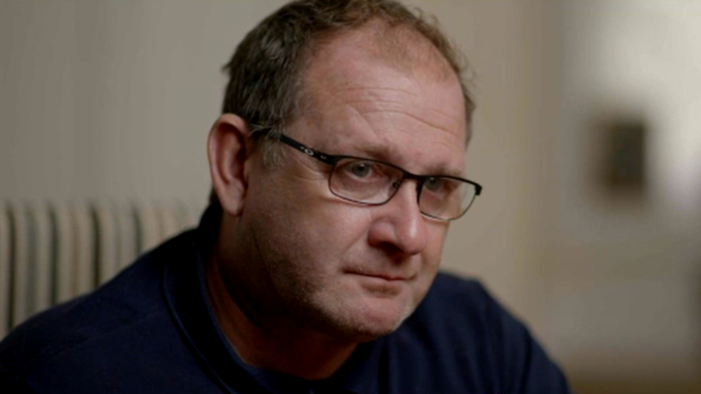 Neil Berriman, a man wearing glasses and a navy top.