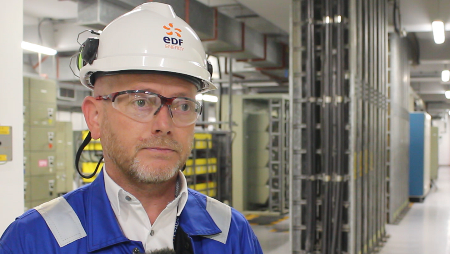 Gavin Rousseau - a Sizewell B employee. He is wearing a hard hat and glasses and looking just past the camera