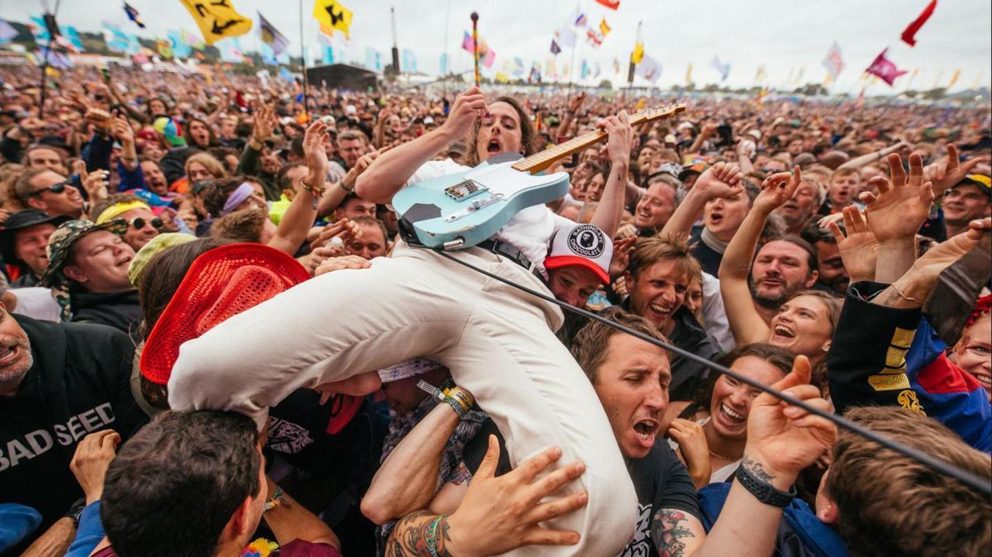 A guitarist from the Idles in the crowd while playing the Other Stage during the Glastonbury Festival at Worthy Farm in Somerset