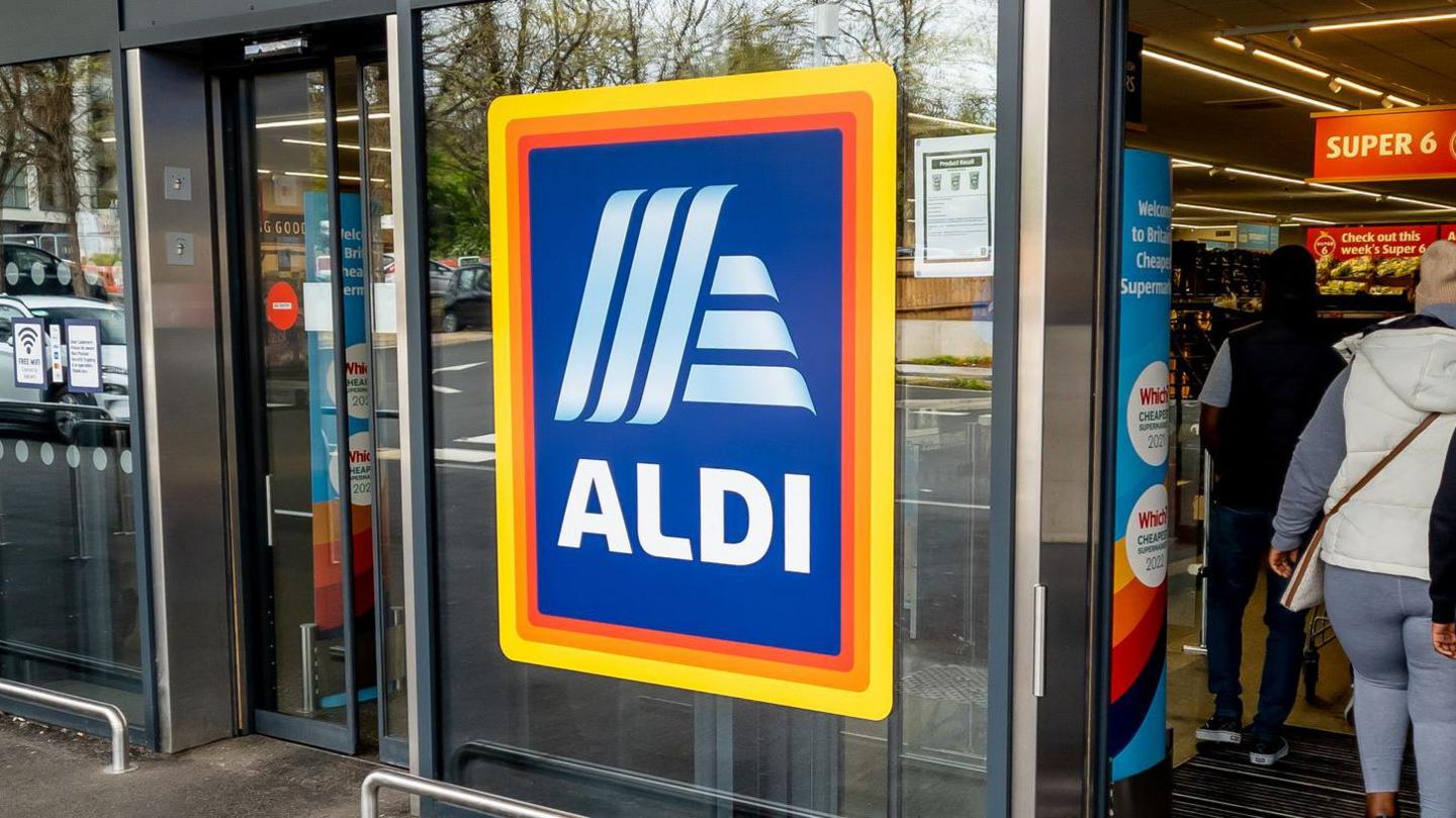 An Aldi logo on the outside of an Aldi supermarket in the UK.