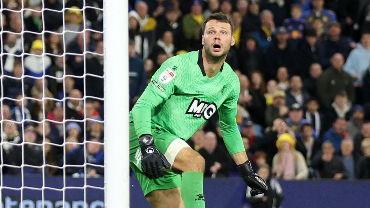 Watford keeper Daniel Bachmann watches as the ball crosses the line for a Leeds United goal