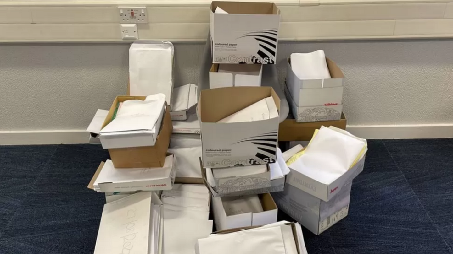 Boxes filled with paper, there are around twenty boxes, which could contain many thousands of pieces of paper, which presumably all have patient information on them