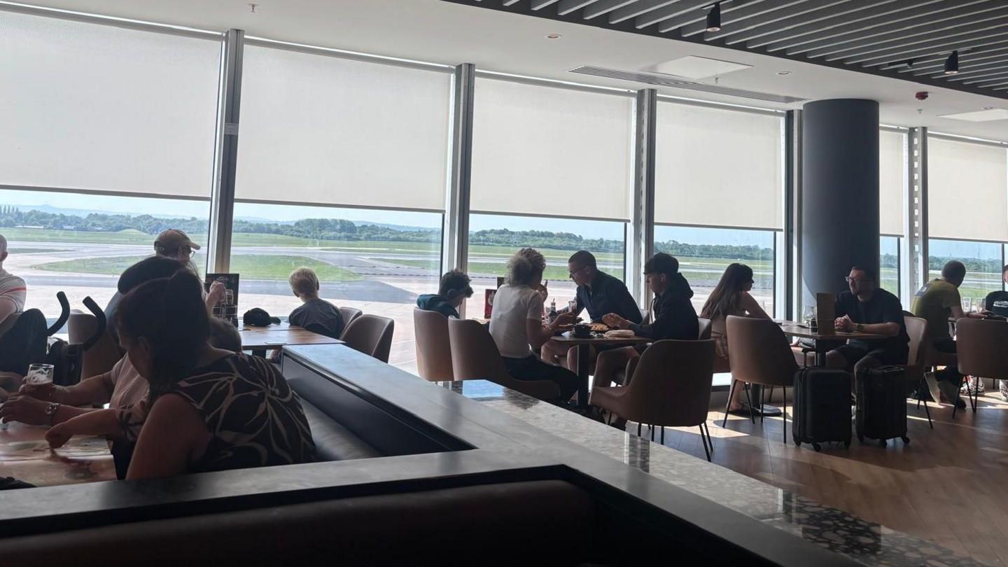 People in the departure lounge at Manchester Airport