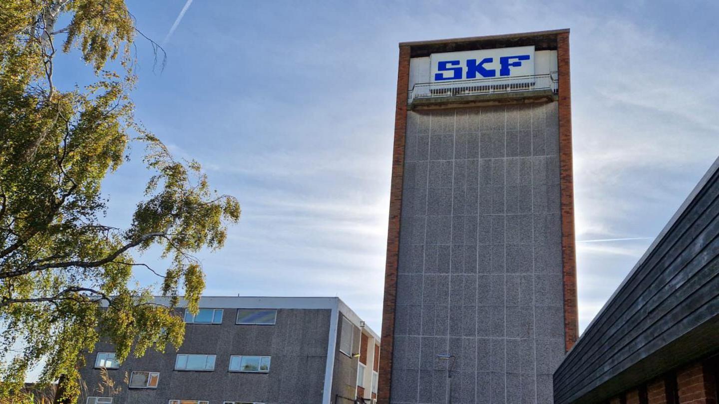 The SKF factory. The picture shows a tall, concrete building with SKF written at the top in blue letters. 