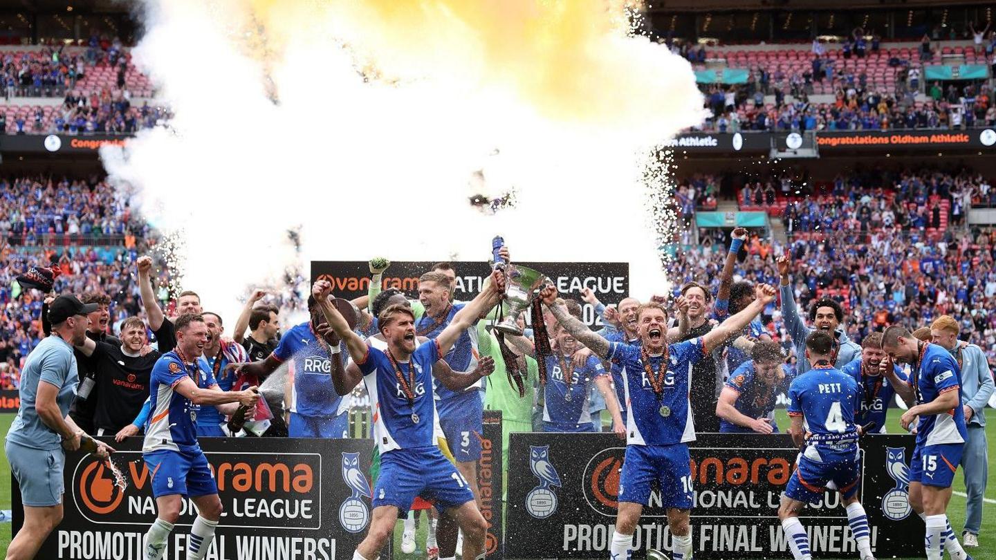 Oldham Athletic players celebrating their trophy win