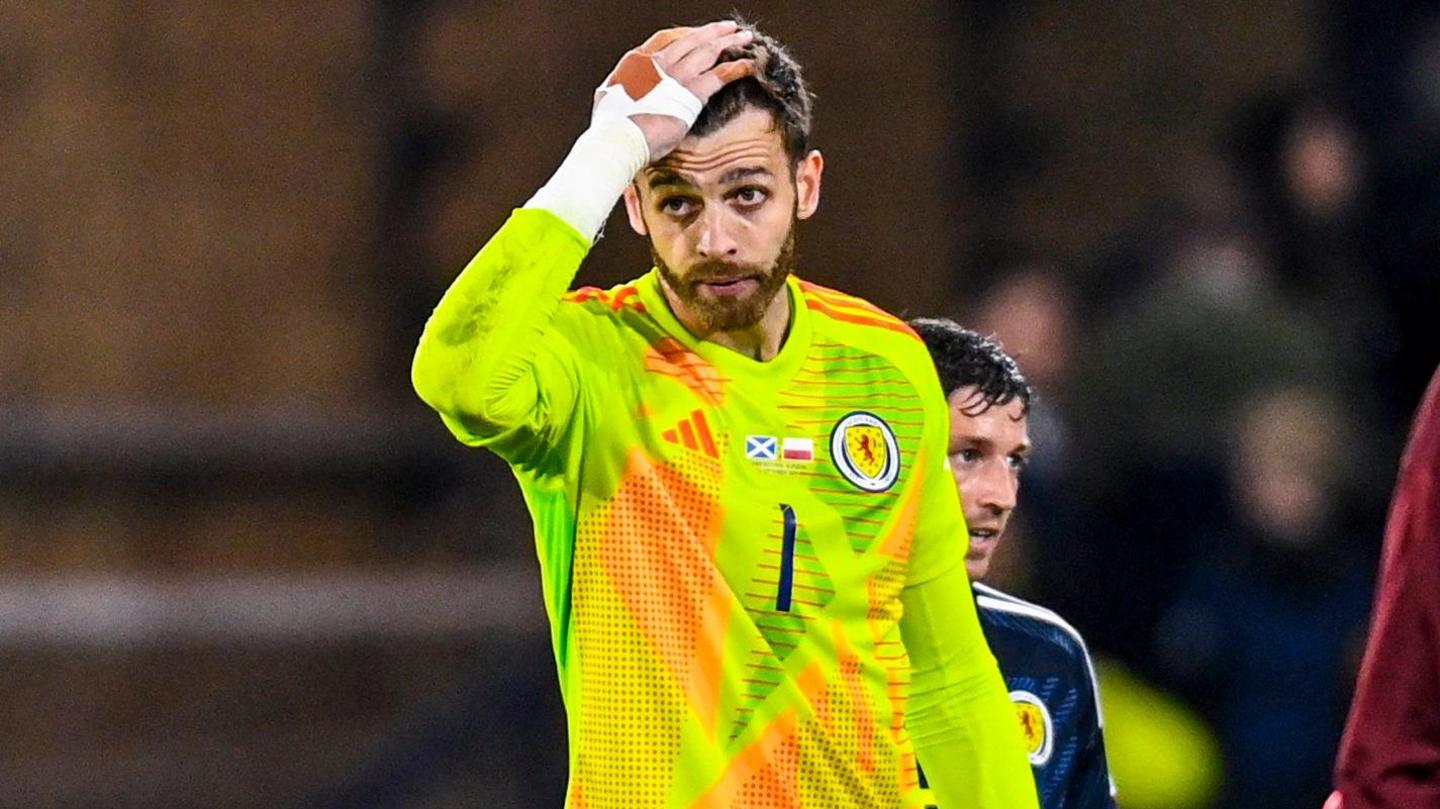 Scotland goalkeeper Angus Gunn looks distressed against Poland