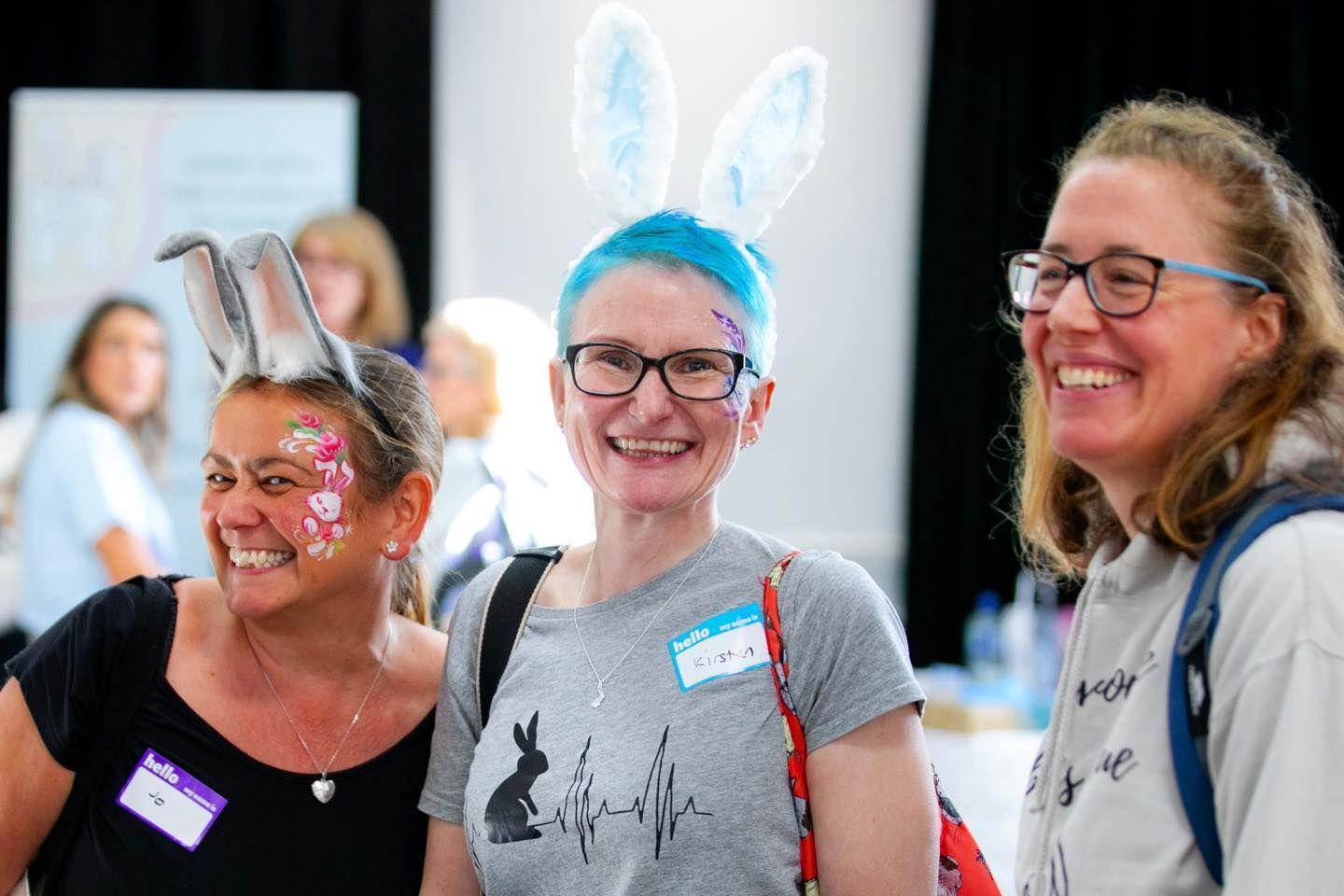 Visitors to a previous National Rabbit Festival, two of them wearing rabbit ears