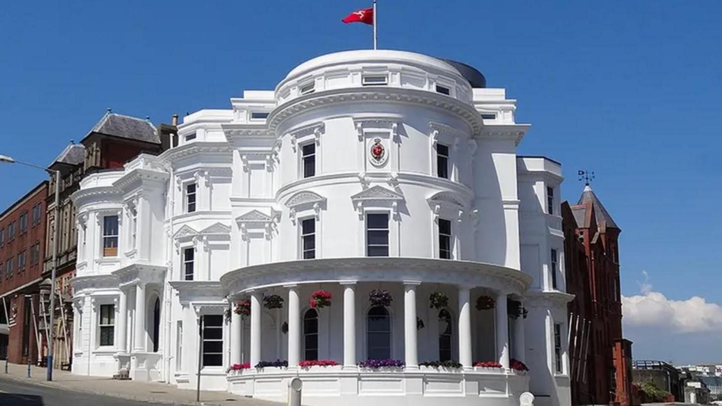 The Isle of Man's parliamentary buildings. Known as the Wedding Cake building, it is a round, white three-tiered building.