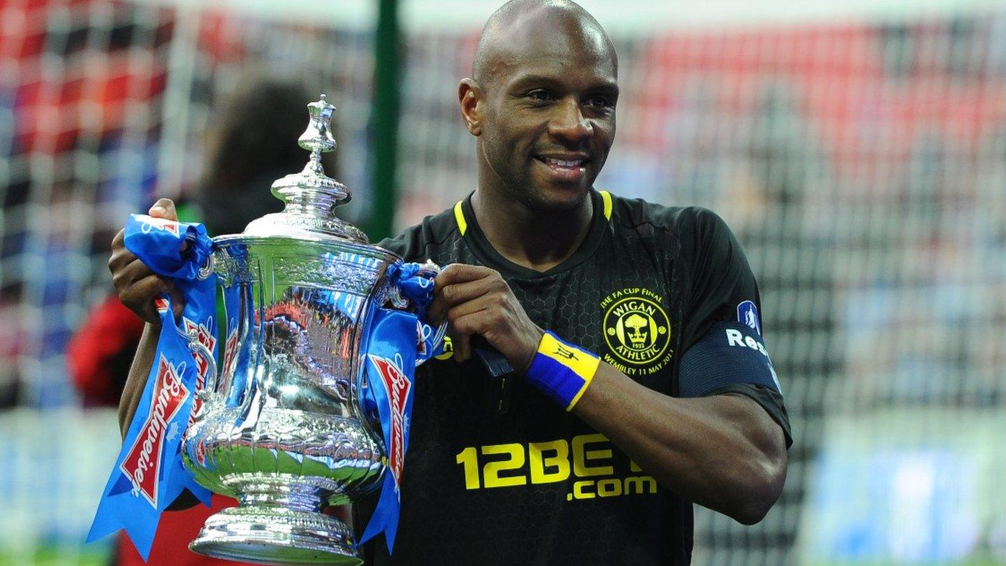 Wigan Athletic's Barbadian defender Emmerson Boyce poses with the FA Cup after beating Man City in the 2013 final