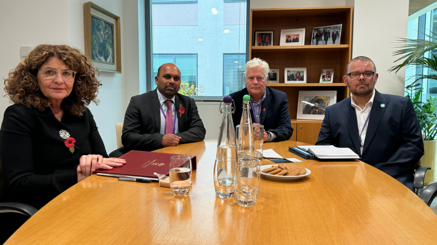 Dame Diana Johnson MP - a woman with curly hair and glasses - sits at a table with Ashford MP Sojan Joseph as well as the two dads Colin Knox and Martin Cosser round a table at the Home Office