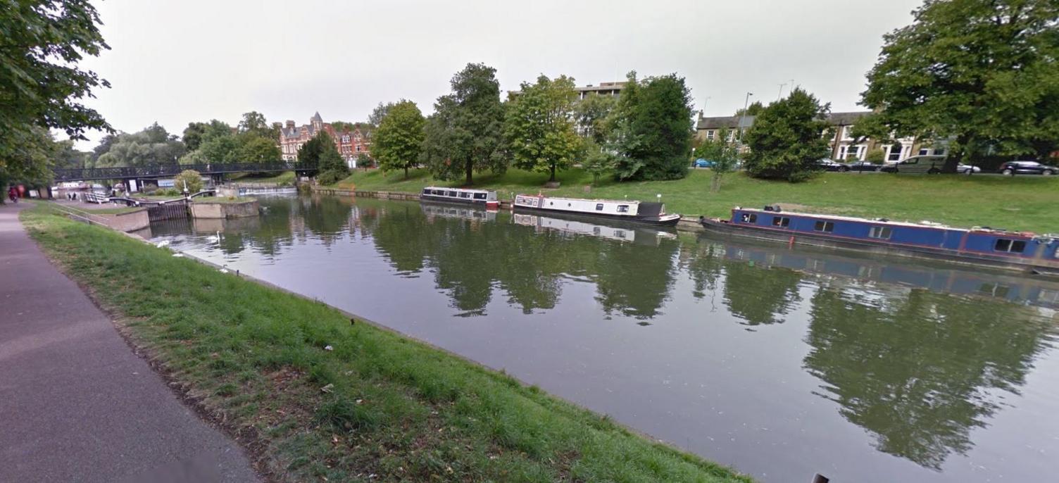 River with barges parked near bank