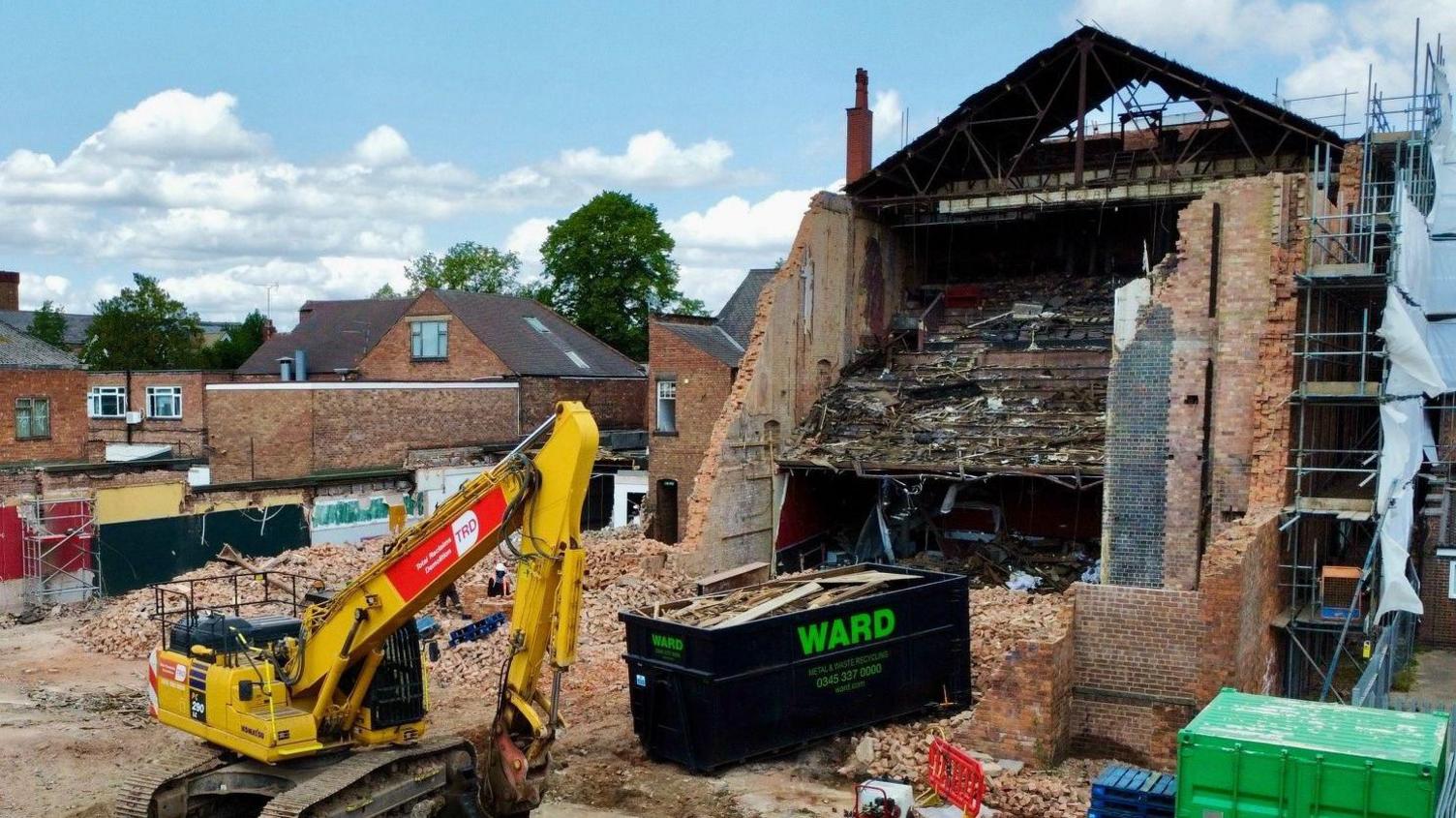 Another lower view of the site showing a digger next to the skeleton of the building