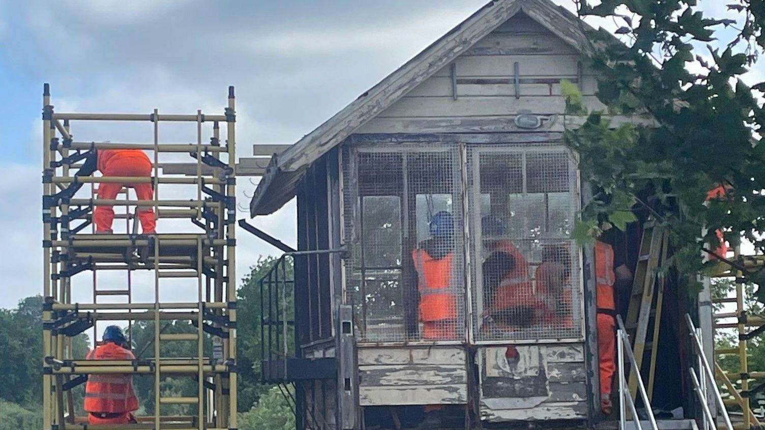 Network Rail engineers stripping out the roof of the signal box in Wye.